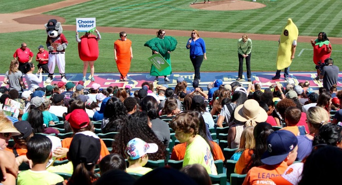 Community event group dressed as fruit and vegetables