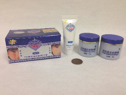 similar to the image above, except including a white squeeze bottle of face cream with blue lettering in chinese