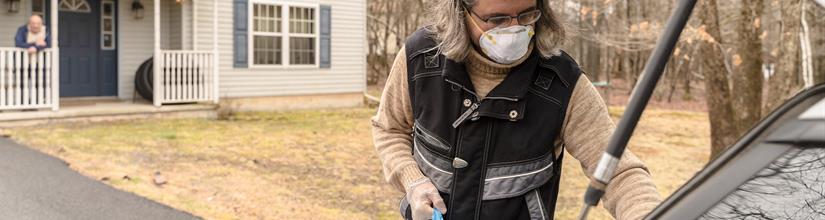Person wearing a mask in smoky condtions returning from food shopping with groceries