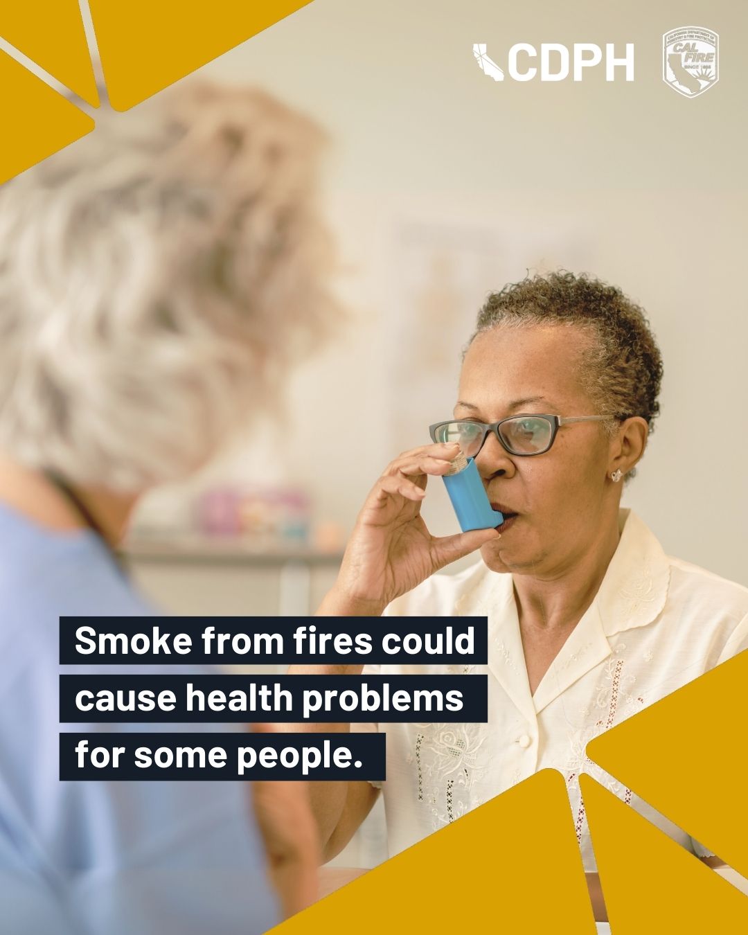 Older person using an asthma inhaler with a health professional. Copy: Smoke from fires could cause health problems for some peo