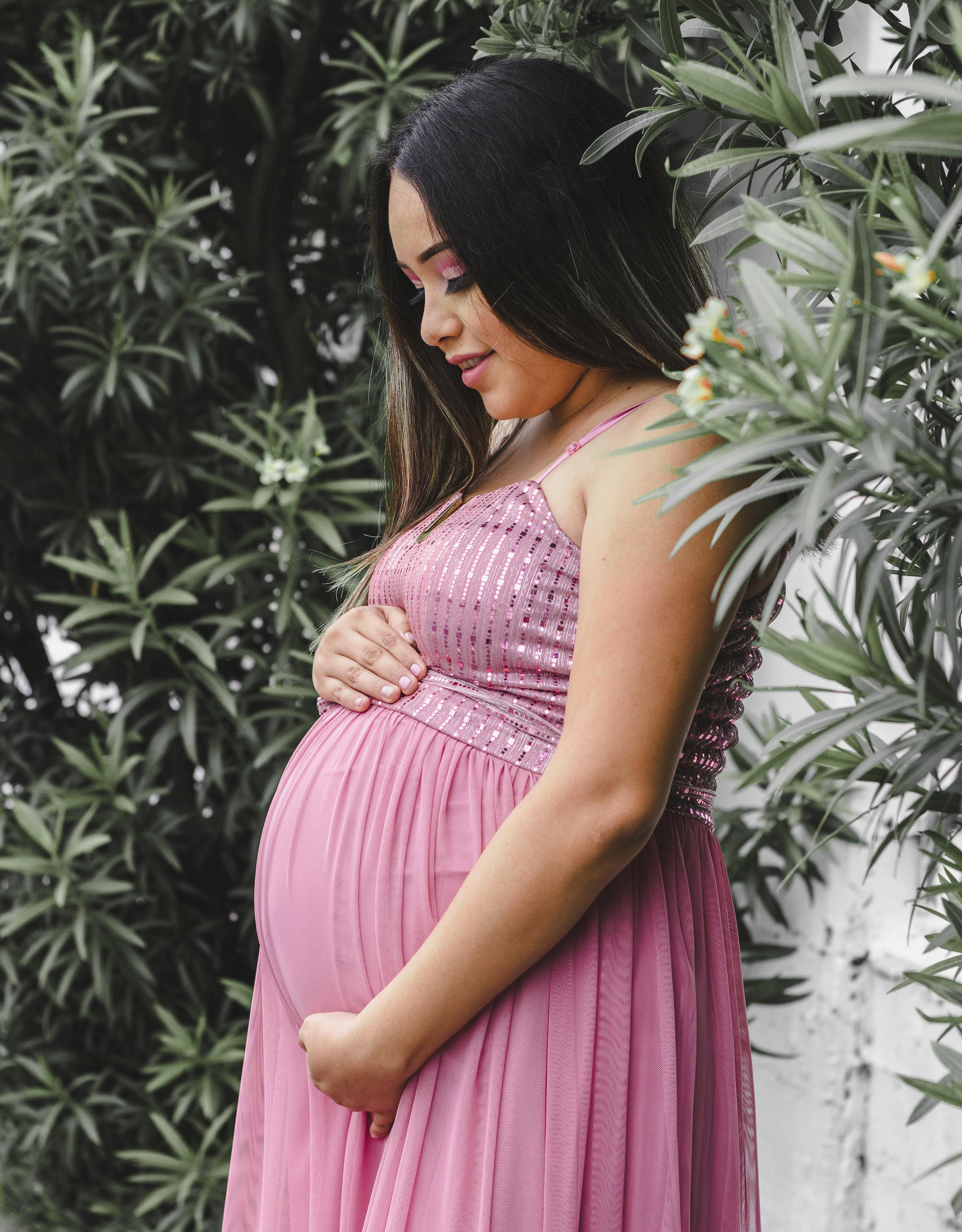 Pregnant person surrounded by plants