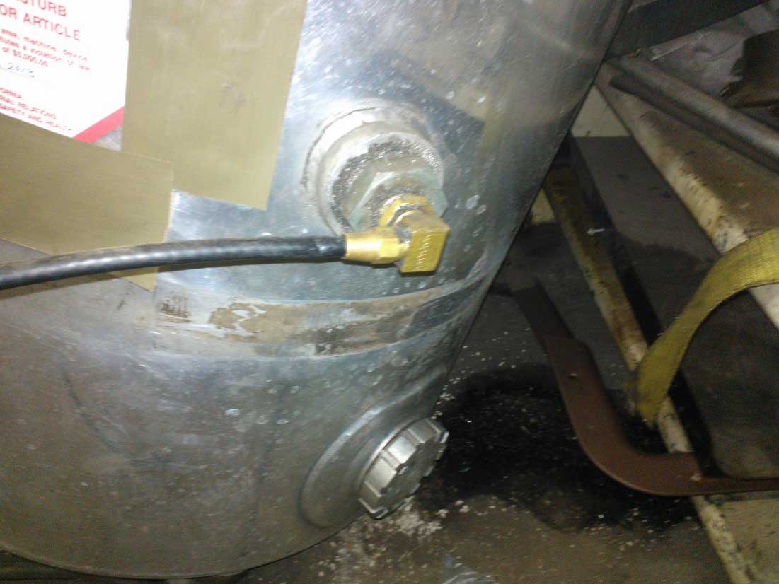 A close up shows the air hose connected to the hydraulic tank.