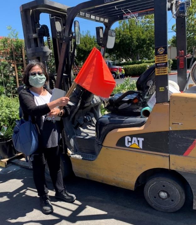 A FACE investigator stands in front of CAT forklift 