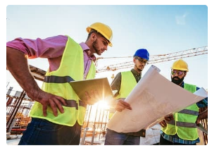 Construction workers reviewing floor plans