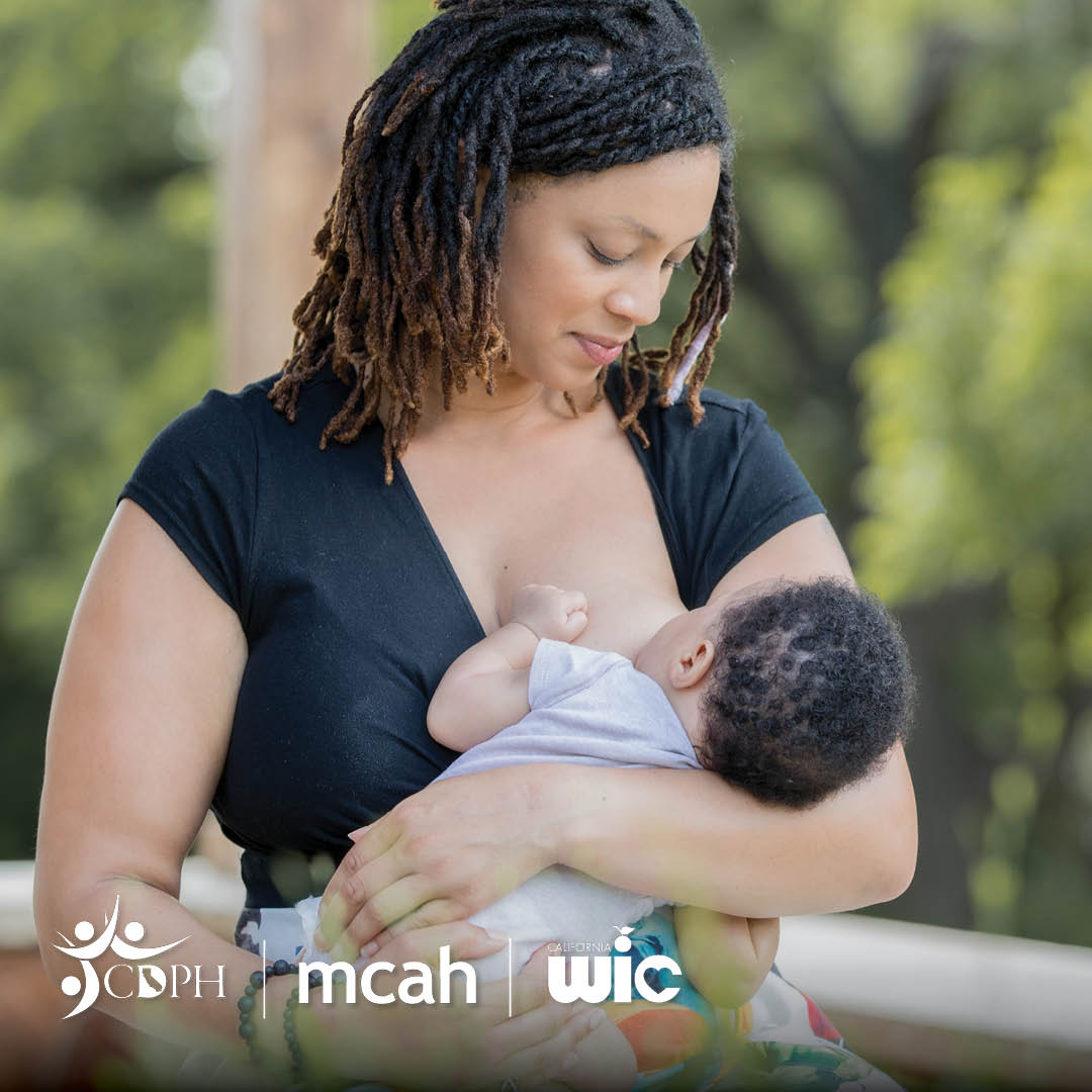 Black women breastfeeding her baby outdoors