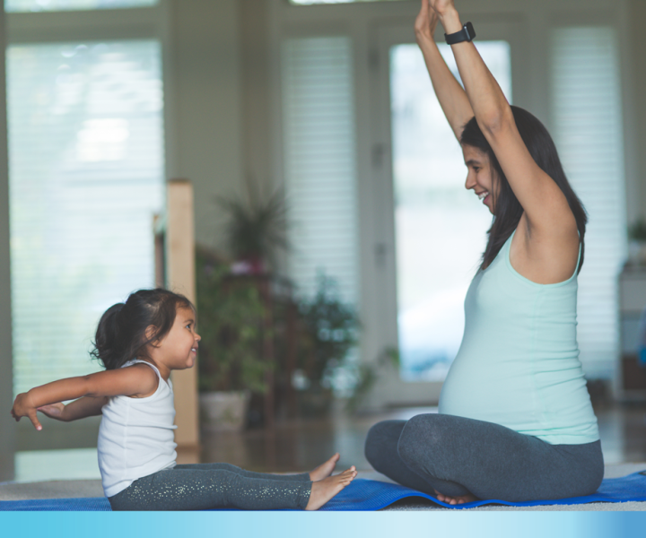 Pregnant mother exercising with her child