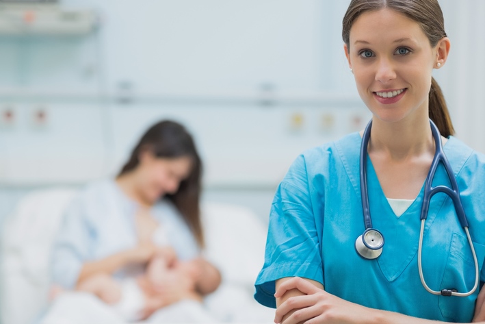 Medical Professional in hospital room with breastfeeding women in background