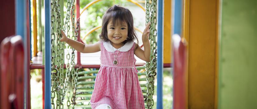 Small girl enjoying playground structure
