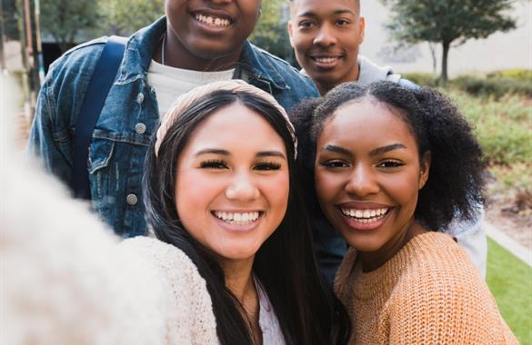 Teens taking a group selfie