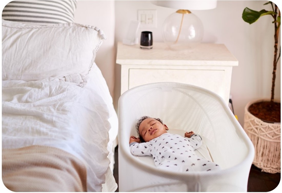 Baby sleeping in bassinet next to, not on, parent's bed