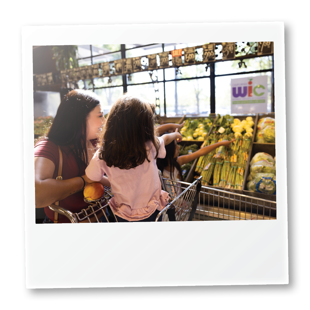 Polaroid of parent and child produce shopping