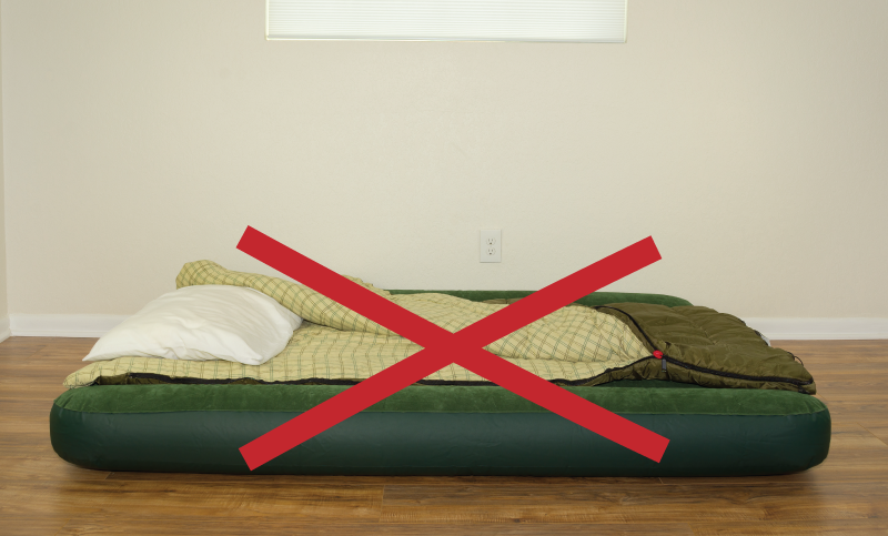 Air mattress on the floor with a red X through it