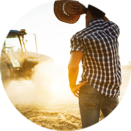 Person and tractor in dusty field