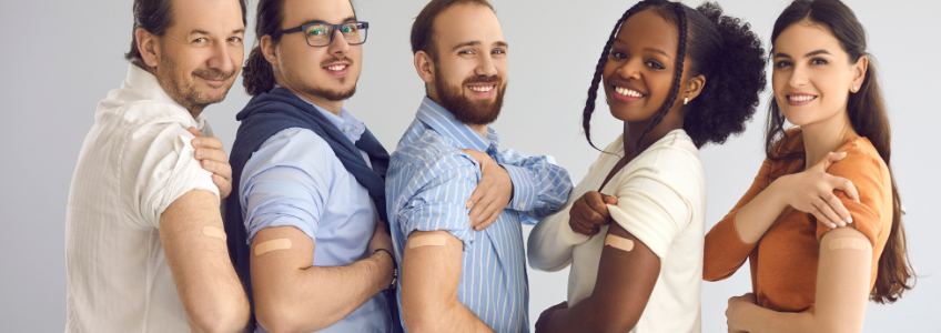 Group showing their shoulder where they were vaccinated.