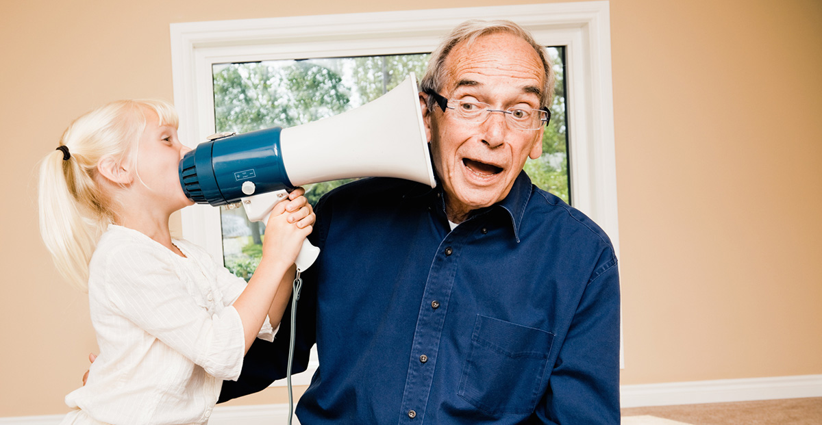 Grandaughter talking through a megaphone to her grandfather