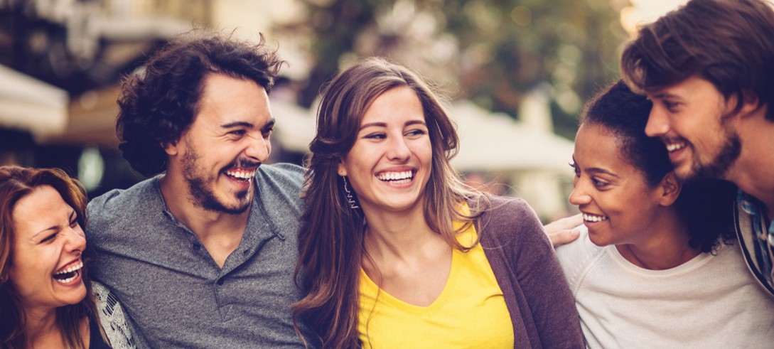 Group with linked arms laughs together