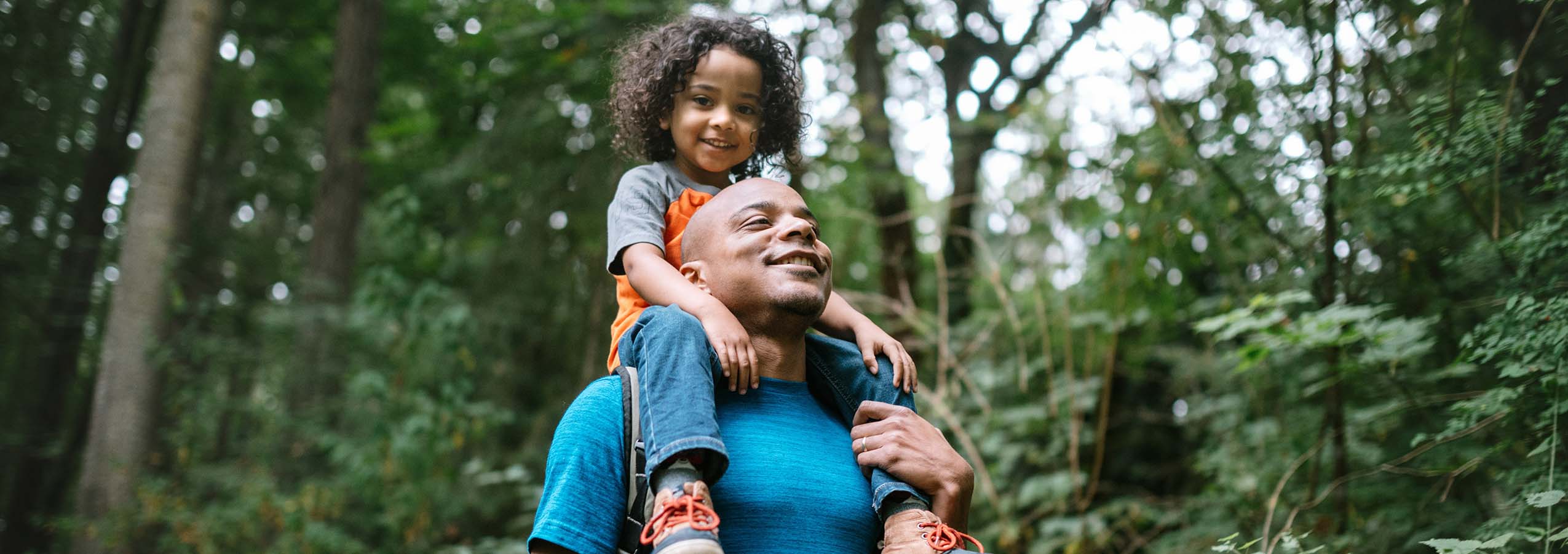 Individual and child in forest