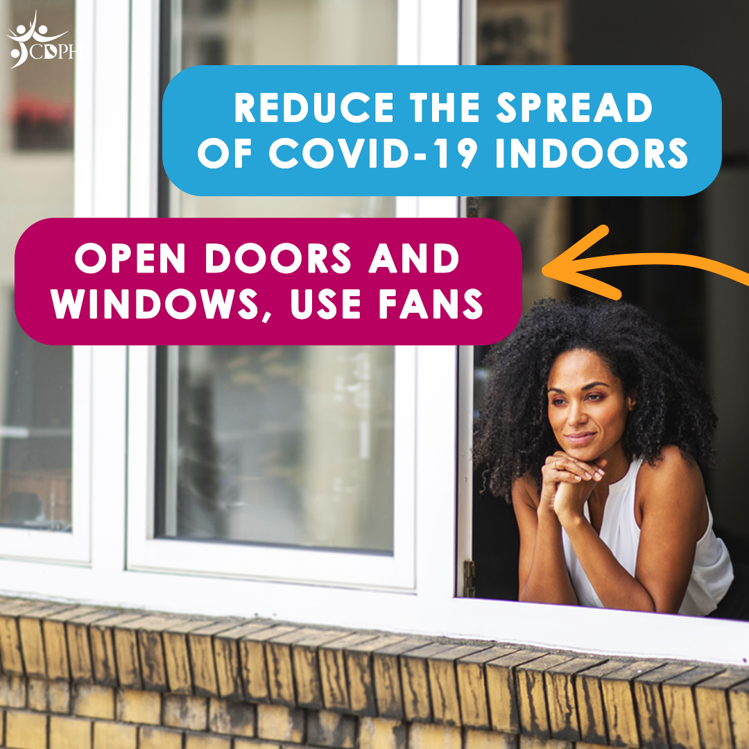 A woman smiling look outside a open window with text overlay, "Reduce the spread of COVID-19 indoors. Open doors and windows, us