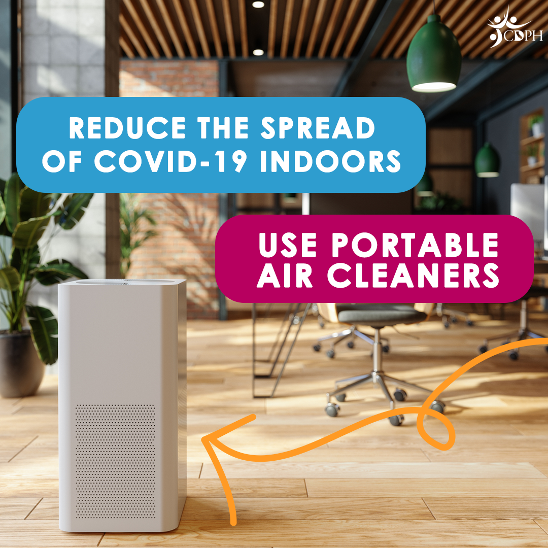 Air purifier in open office with text overlay, "Reduce the spread of COVID-19 indoors. Use portable air cleaners."