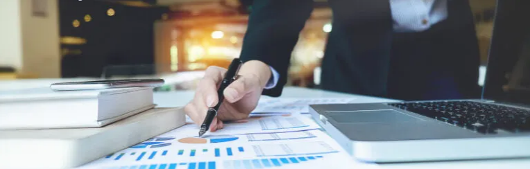 Man pointing at a chart on a table