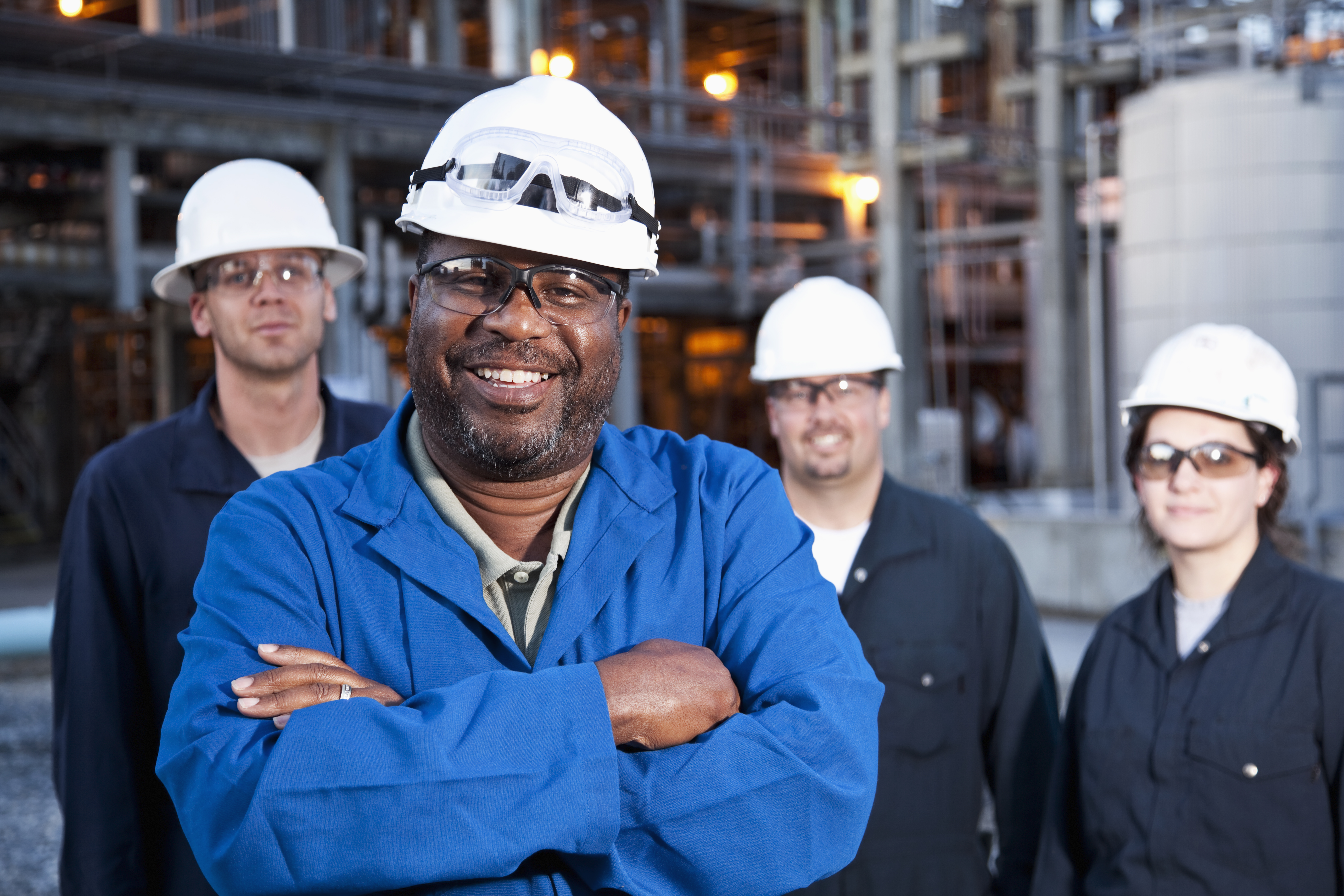 Workers standing in front of factory. Workers standing in front of factory.