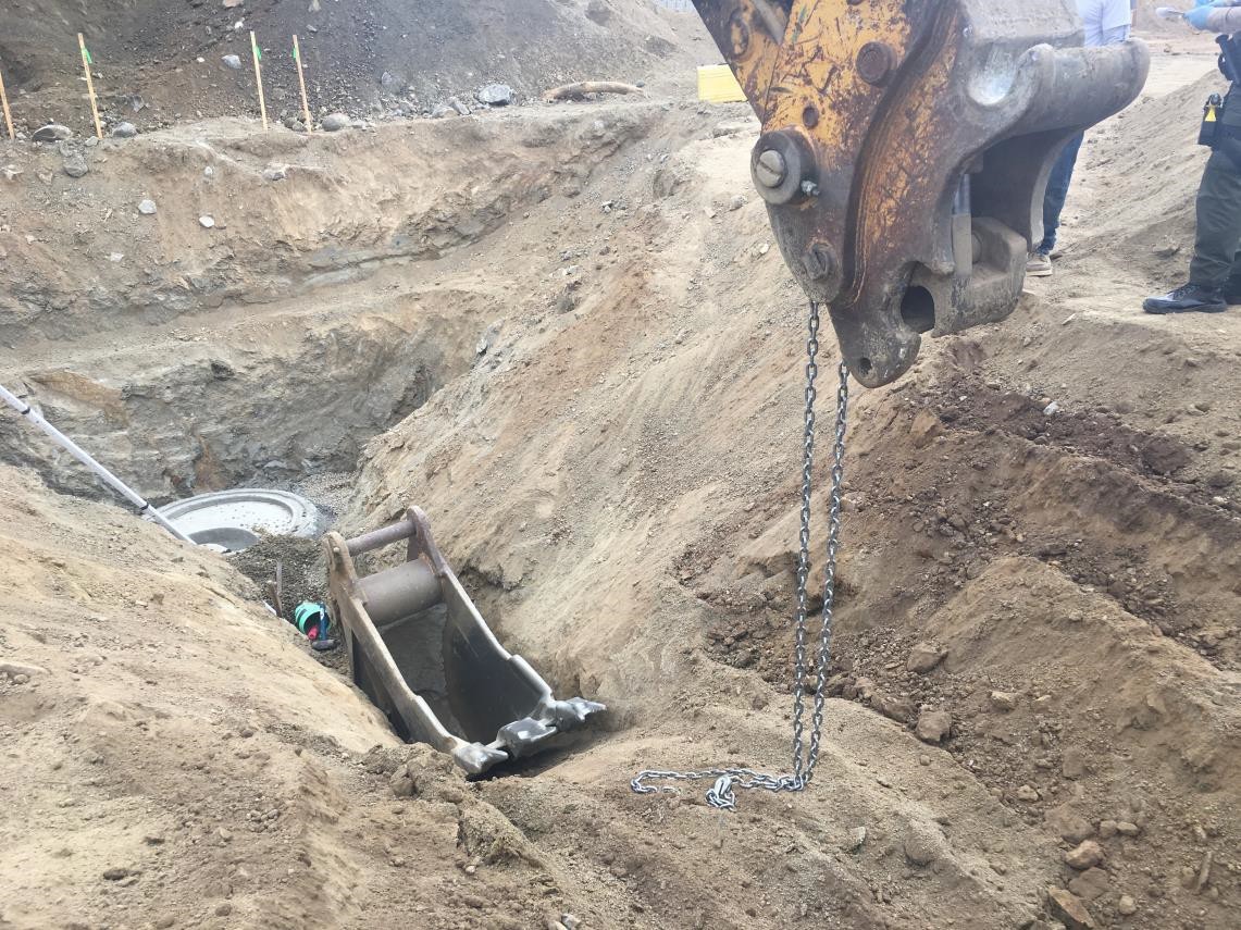 view of a trench from the side wth the detached digging bucket inside view of a trench from the side wth the detached digging bucket inside