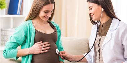 Health professional evaluating pregnant individual