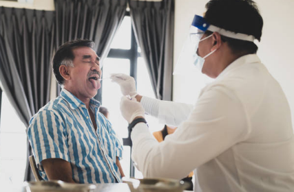 Man getting swab test taken. Man getting swab test taken.