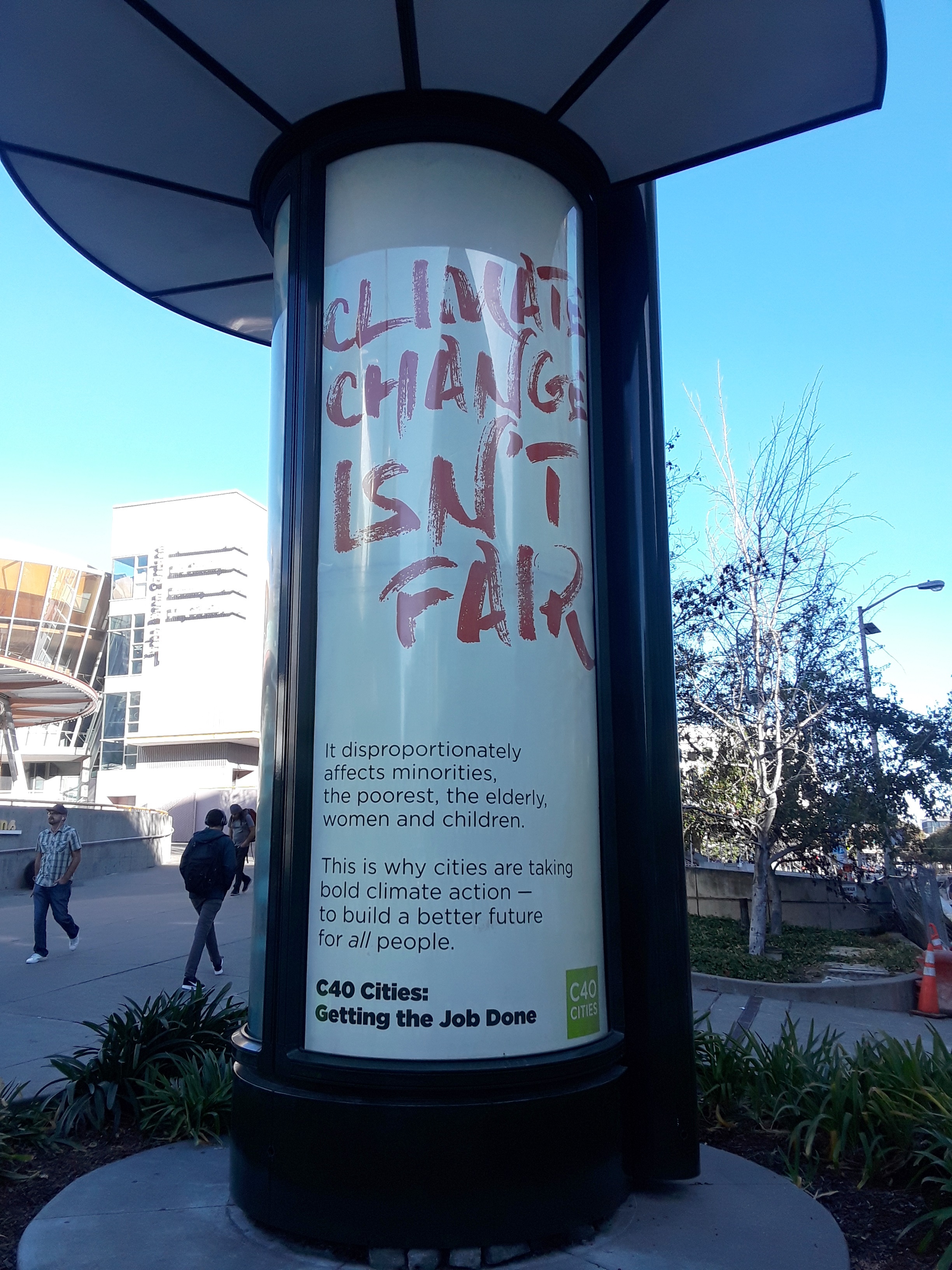 Street display showing "Climate Change Isn't Fair"